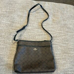 COACH crossbody bag, 12’ wide x 10’ deep, dark brown with COACH logo.
